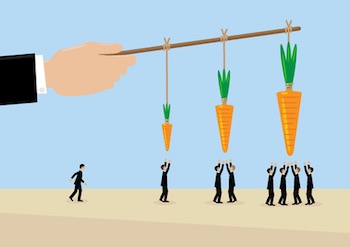 A large hand holds a carrots on a stick. a metaphor on management, incentive and leadership.