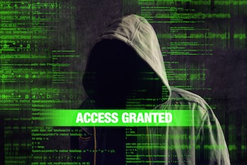 Access granted to Faceless hooded anonymous computer hacker with programming code from monitor