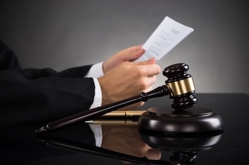 Judge reading court documents w/ gavel