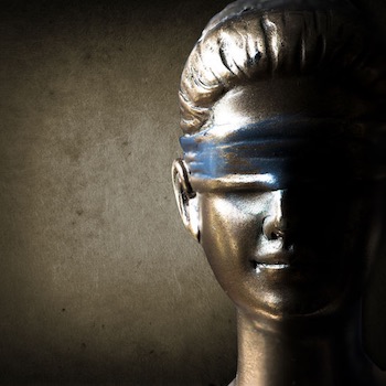 69894612 - face of lady justice in dark brown background