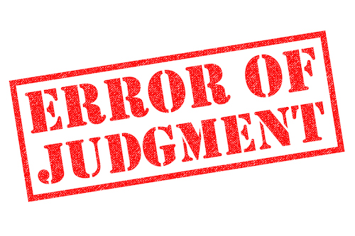 ERROR OF JUDGMENT red Rubber Stamp over a white background.