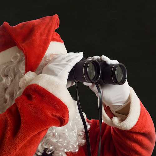 Santa Claus looking at the future business strategy with binoculars to the right